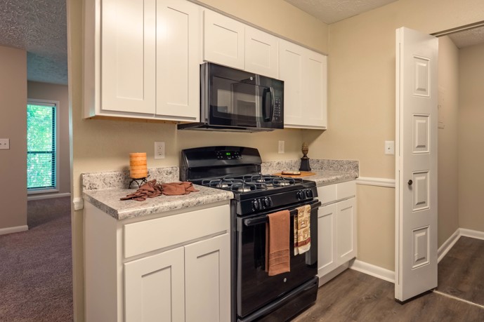 Another view of the kitchen area, showcasing its spacious layout, modern amenities, and ample storage options for residents' convenience.